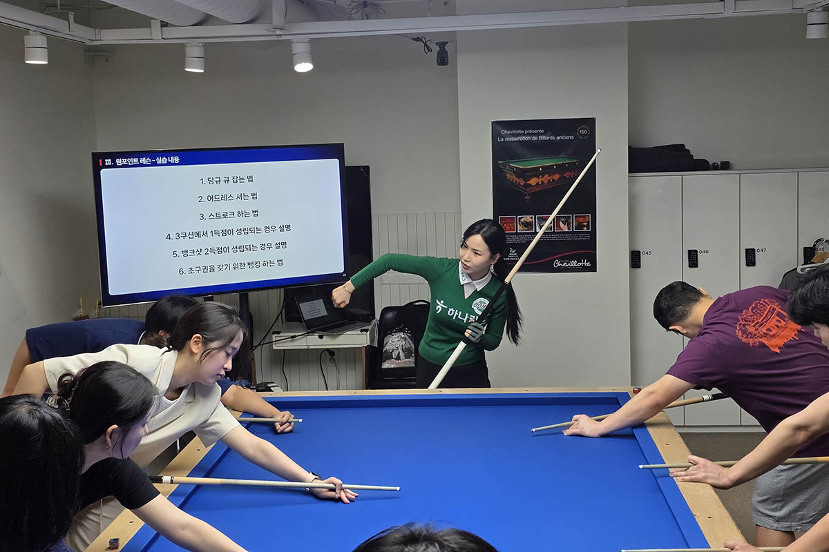 학생들에게 당구 원포인트 레슨을 하고 있는 김진아.