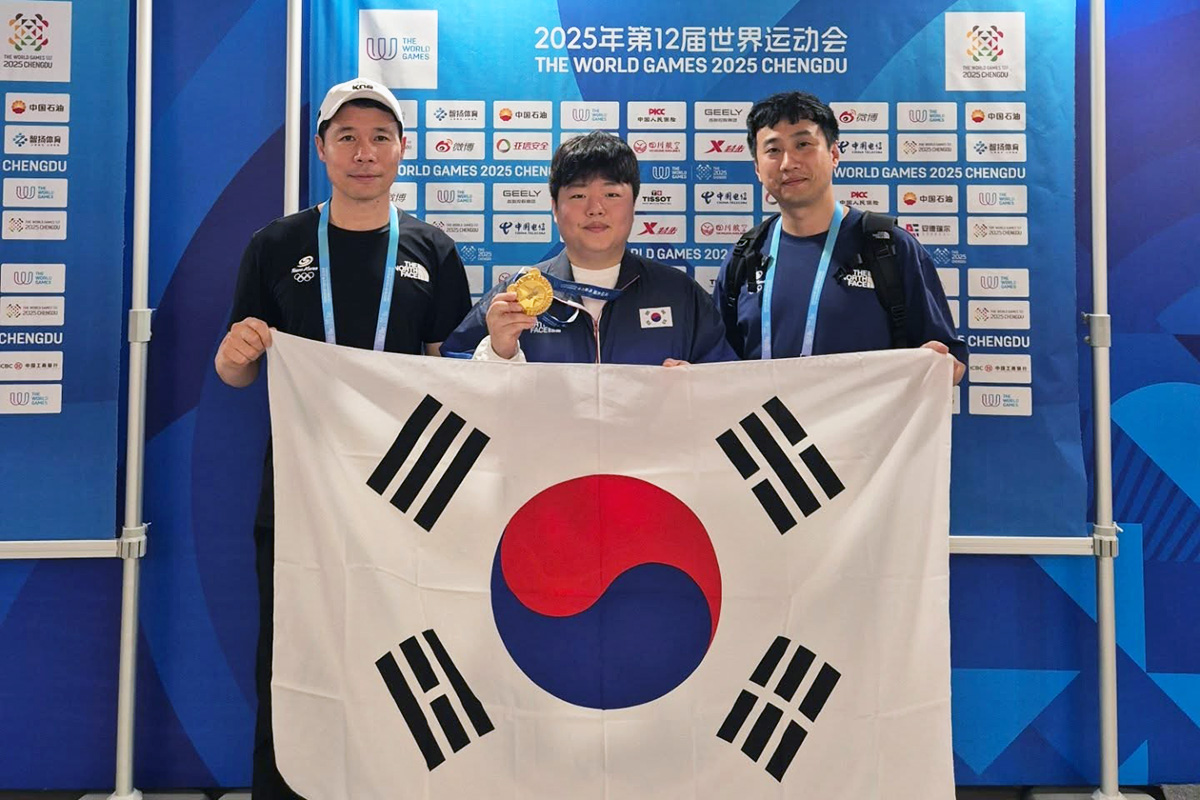 시상식 후 이번 대회에 국가대표로 함께 출전한 허정한(왼쪽)과 감독 홍진표(오른쪽)이 태극기를 펼쳐 들고 기념사진을 찍고 있다. 가운데는 금메달을 목에 건 조명우. 